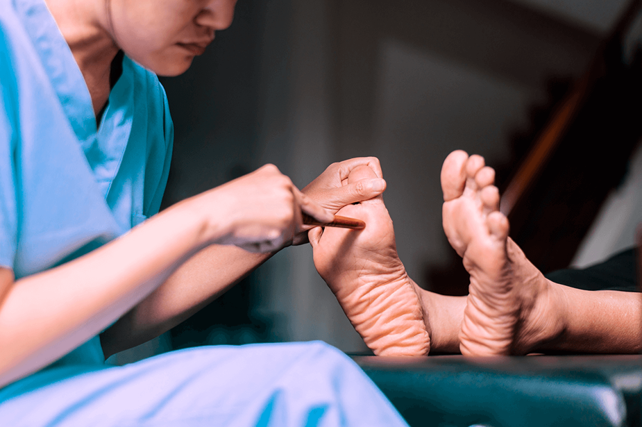 אחות בודקת את הרגליים של מטופל סוכרת