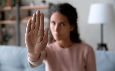 A woman makes a stop with her hand