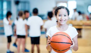 ילדה מחזיקה כדורסל