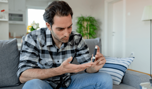 A man measures blood sugar