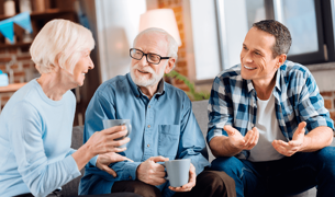 An elderly couple and their son are having a conversation