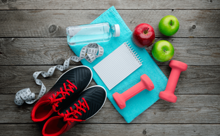 Sports shoes, a towel and three apples