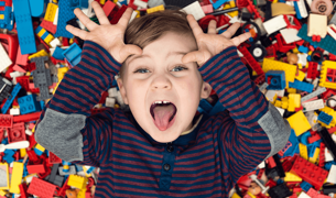 A boy on a pile of legos