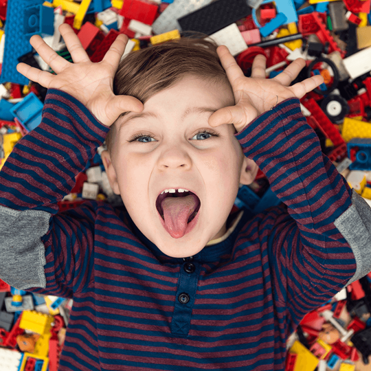 A boy on a pile of legos