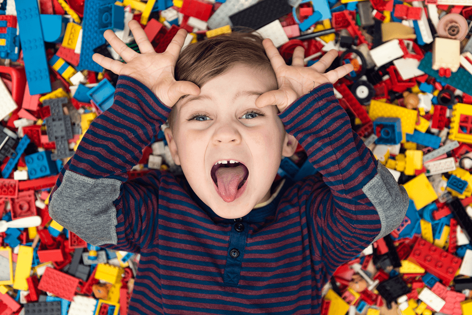 A boy on a pile of legos