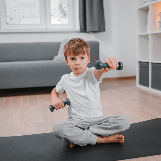 A boy lifts weights