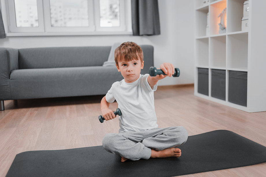 A boy lifts weights